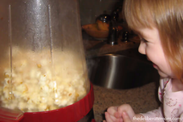 This moment of a child enjoying the popping of popcorn.