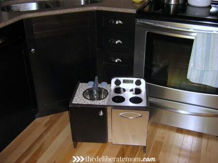 A play kitchen DIY project! We worked to make this kitchen look like our own kitchen. It was inexpensive and was built from the base of a small IKEA end table. Easy, cute, inexpensive and original! Check out these instructions on how to build a build a play kitchen! 