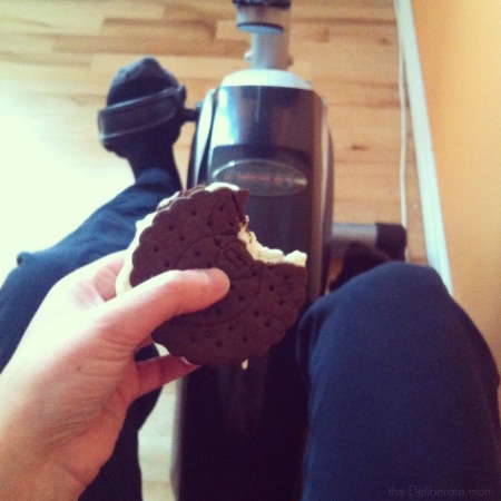 Eating an ice cream sandwich while riding an exercise bike